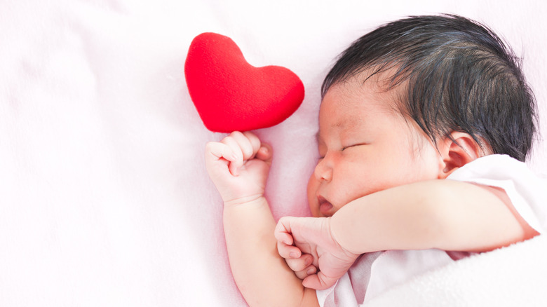 baby girl with a stuffed red heart