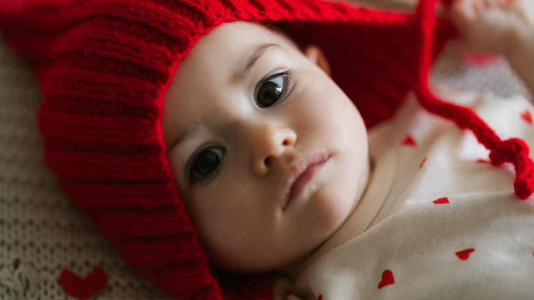 baby girl in a red hat