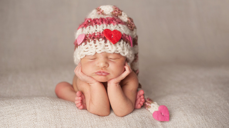 newborn baby in a heart hat