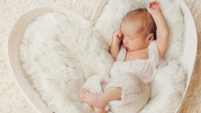 baby in a heart-shaped bassinet