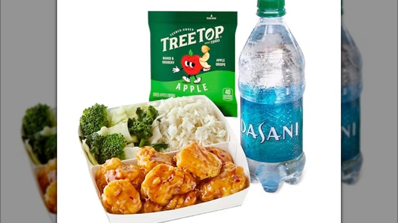 Stock image of the Panda Express Orange Chicken Cub Meal with super greens, rice, dried apples, and a water bottle