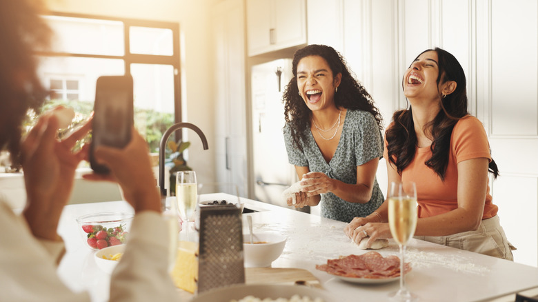 friends together around a kitchen island