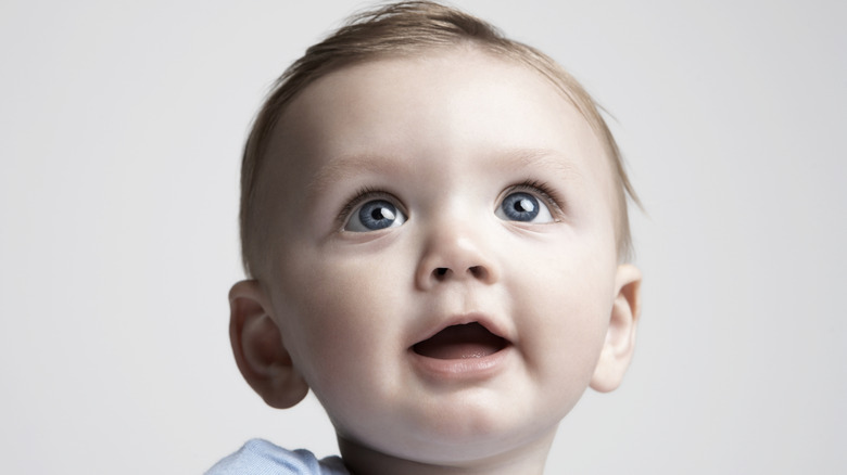 A close-up of a baby's face looking up