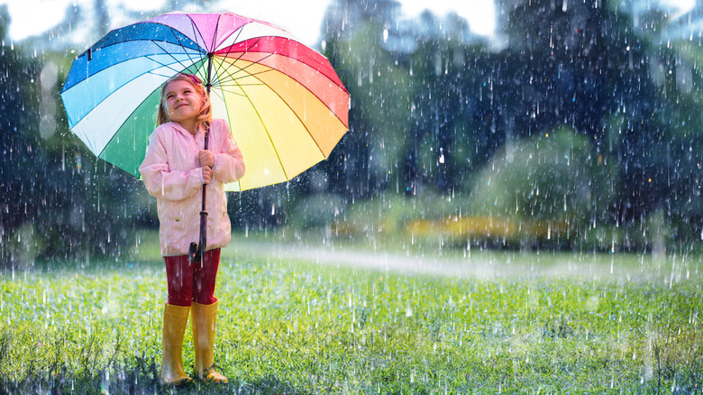 little girl playing in the rain