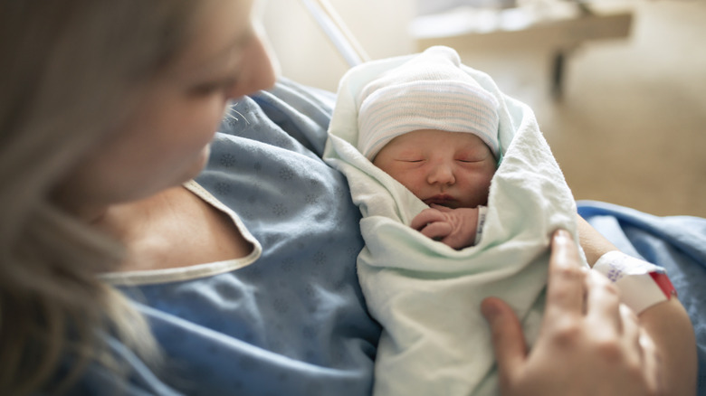 Mother holding a newborn baby in the hospital
