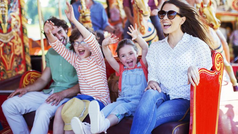 Family laughing on amusement park ride