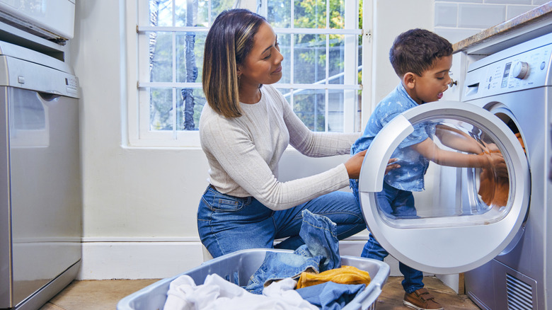 mother and child doing laundry together