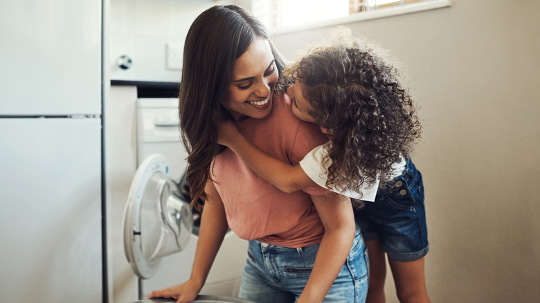 mother and child doing laundry