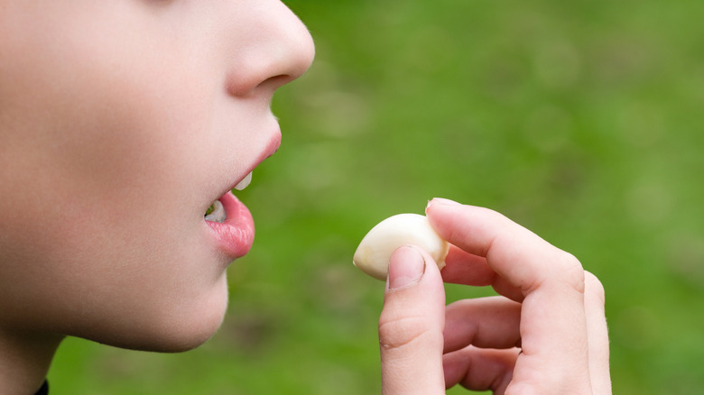 child eating a clove of garlic raw