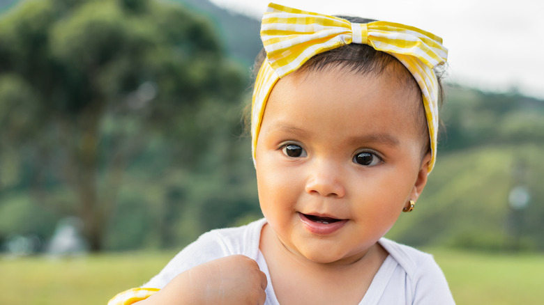 Baby girl smiling with hair tie