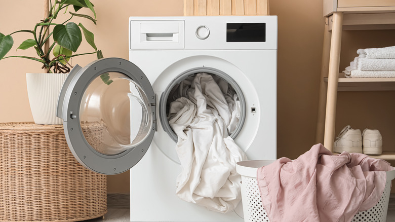 laundry machine stuffed with bedding