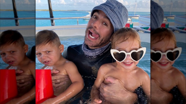 Enrique Iglesias holds his twins in a pool