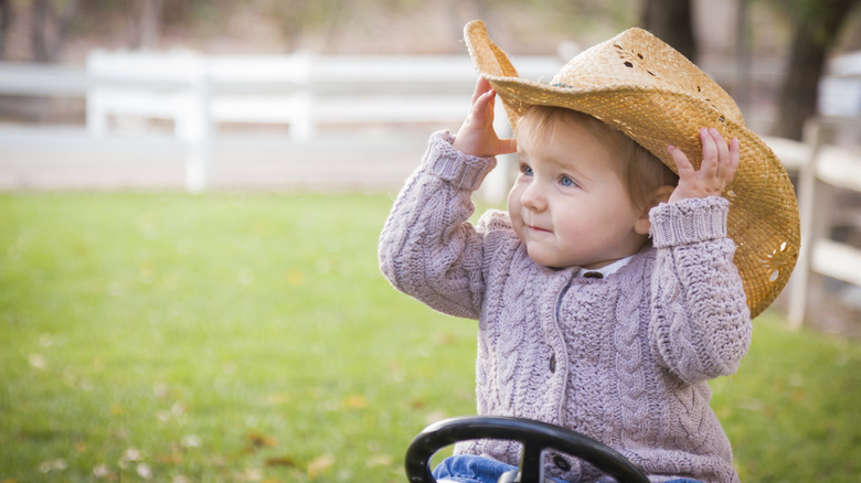 baby girl in a cowgirl sunhat
