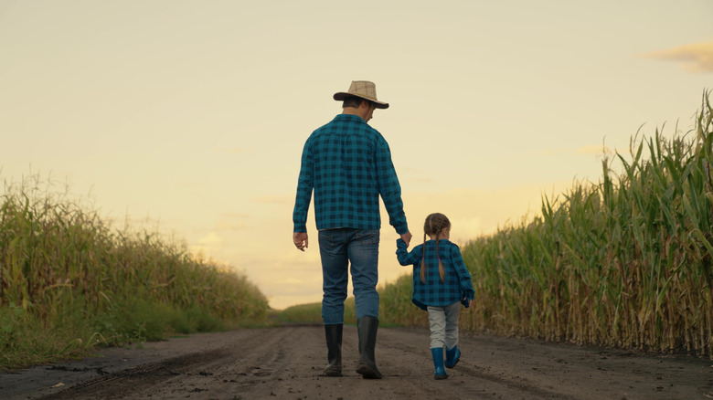 father and daughter in a corn field