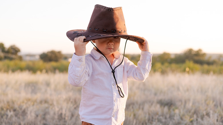 little boy in a cowboy hat