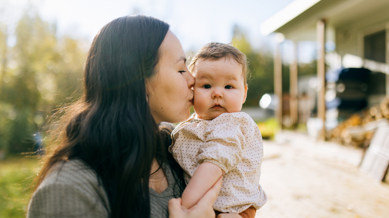 sweet baby girl and her mother outside together