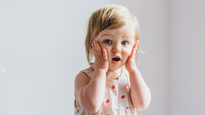 little girl looking shocked