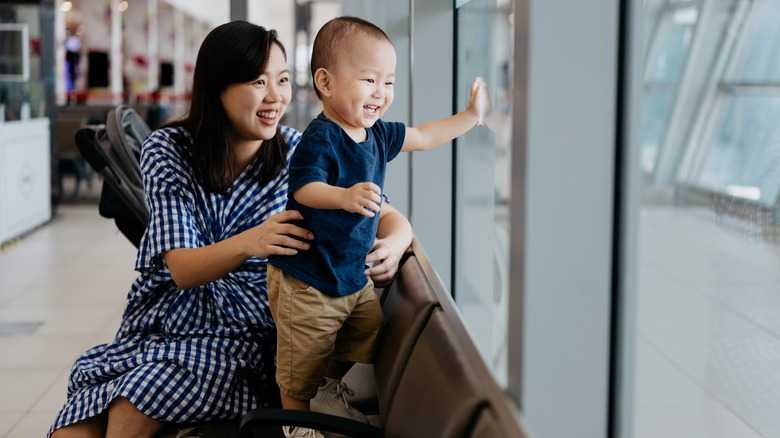 happy mom and toddler in an airport