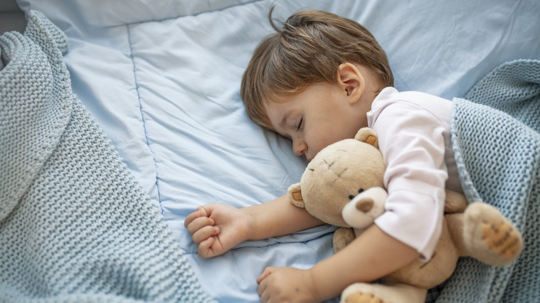 Toddler sleeping in bed