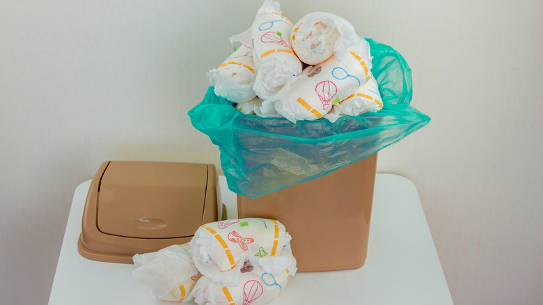 diaper disposal bin overflowing with dirty diapers