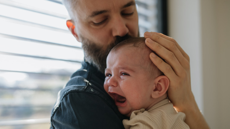 Father comforting crying baby