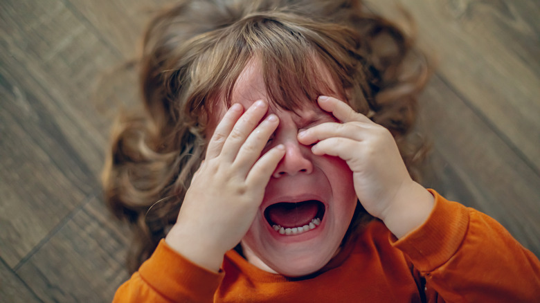 Girl crying while on the floor