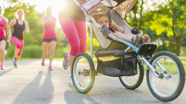 little girl sitting in a jogging stroller