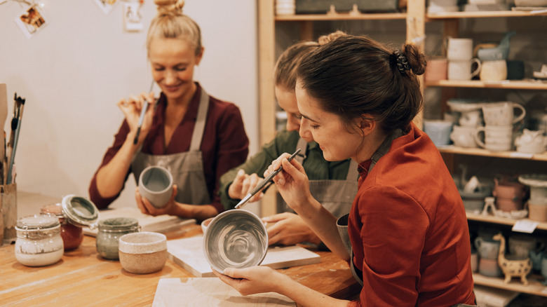 women in a pottery class together