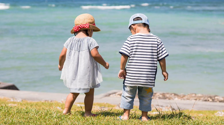 twins playing on the beach