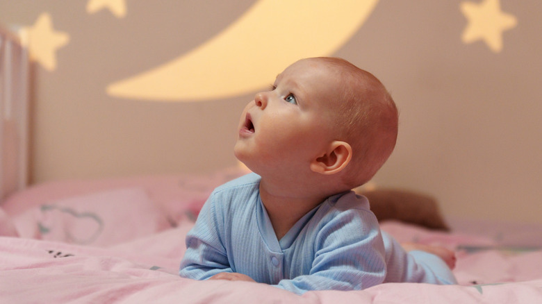 baby in front of a stars and moon backdrop